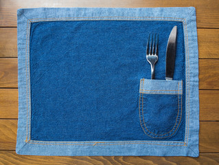 Knife and Fork placed in a jeans napkin' pocket