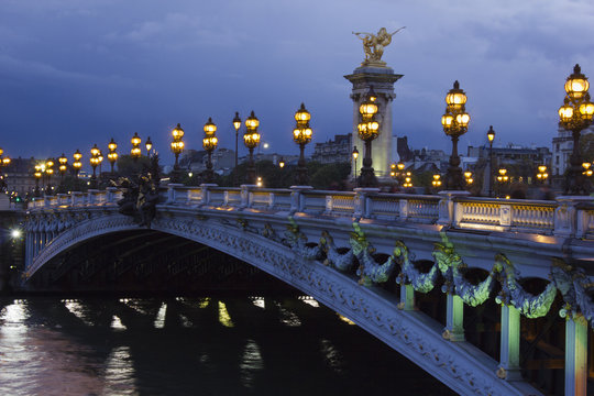 Alexander the Third bridge and Seine under shining lamps at nigh
