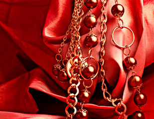 golden beads on a red silk - 46728058