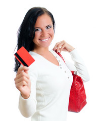 Naklejka premium Smiling woman with red credit card and bag. Isolated on white.
