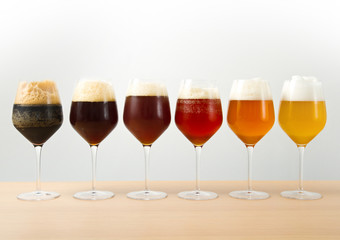 six glasses with different beers