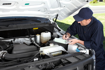 Car mechanic working in auto repair service.