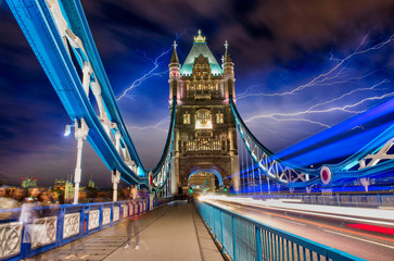 Light trails in Tower Bridge Road at night with storm