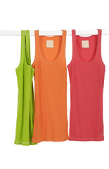Three colorful clothing on wooden hangers