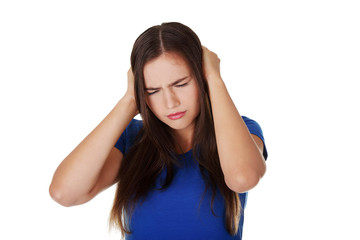 Frustrated young woman holding her ears
