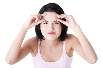 Fototapeta premium Beautiful shocked woman checking her wrinkles