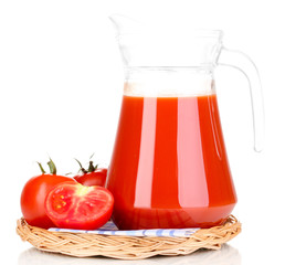Tomato juice in pitcher on wicker mat isolated on white