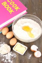 Eggs, flour and butter close-up on wooden table
