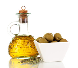 Green olives in white bowl with rosemary and olive oil isolated