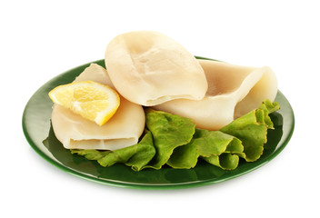 boiled squids with lettuce and lemon in the plate isolated