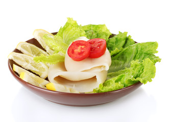 boiled squids with vegetables on the plate isolated on white