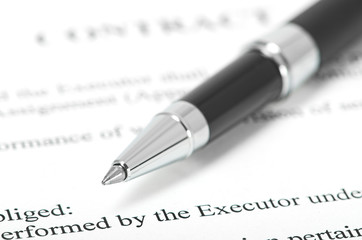 Close-up of silver pen on contract.