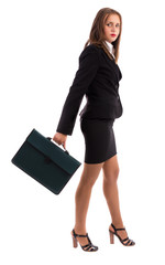 Portrait of a pretty business woman walking with a folder