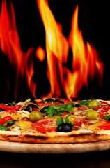 Foto op Plexiglas Delicious pizza close-up on wooden table on fire background © Africa Studio