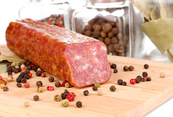 Tasty sausage on chopping board close-up