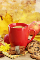 cup of hot tea and autumn leaves, on rain background