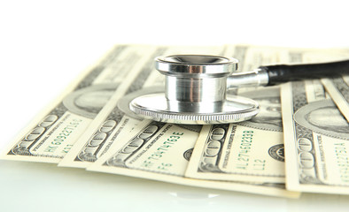 Healthcare cost concept: stethoscope and dollars isolated