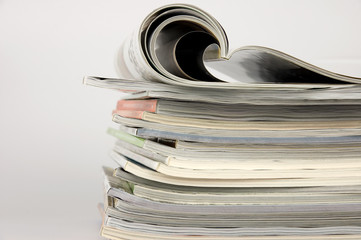 Pile of magazines over white background