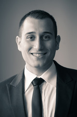 Portrait of young happy businessman. Black and white image.
