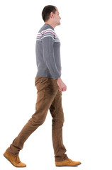 Naklejka premium Back view of going handsome man in sweater