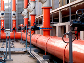 valves and orange steel pipes at cooling tower