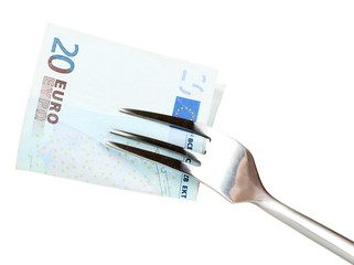 Banknotes on a fork on white background close-up