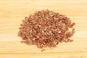 flax seeds on wooden background close-up