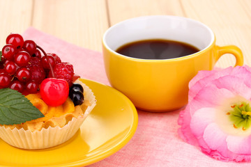 Dulcet cake with fruit and berries on wooden table