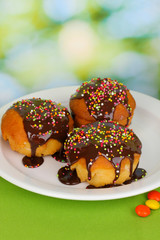 Appetizing cupcakes with chocolate on nature background