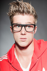 Fashion studio portrait young man with retro glasses.