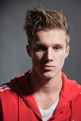 Obraz premium Fashion portrait of sportive young man wearing red jacket.