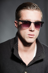 Fototapeta premium Fashion beauty portrait of young man with retro sunglasses.