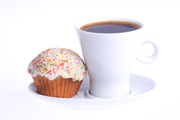 coffee with a cupcake with sprinkles on a saucer