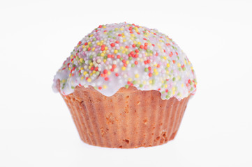 muffin glazed with colored sprinkles on a white background