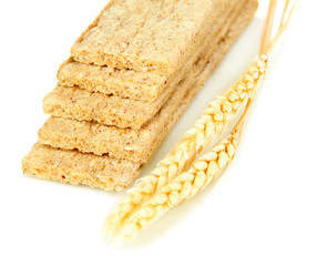 Oat biscuits and wheat ears isolated on white