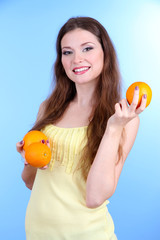 Beautiful woman with orange on blue background