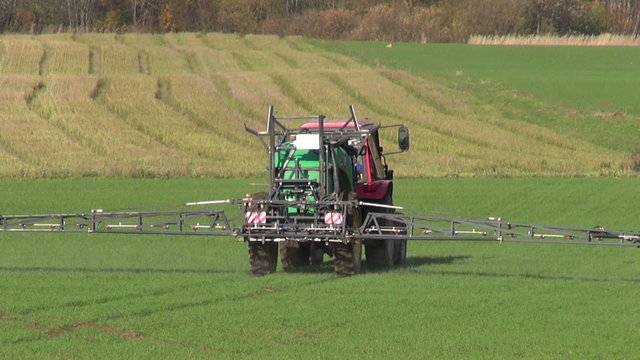 tractor spray autumn season green crop field