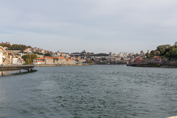 Fototapeta premium View of Porto city at the riverbank (Ribeira quarter) and wine b