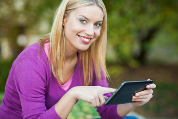 Woman using digital tablet outdoors