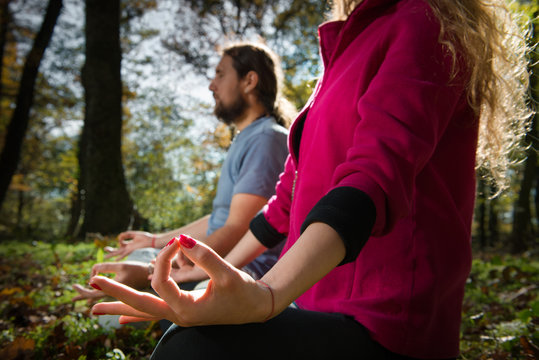 Couple Doing Yoga Meditation In A Forest