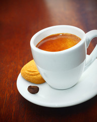 Espresso coffee served with a biscuit