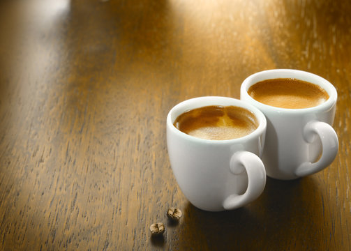 Two cups of freshly brewed espresso coffee