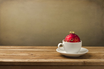 Coffee cup with Christmas decorations on wooden table