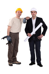 Architect stood with man holding drill