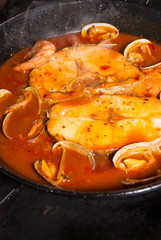 Cooking hake in sauce