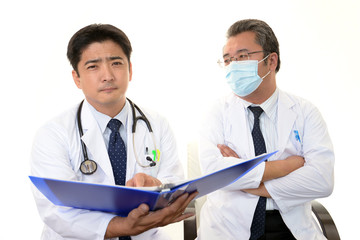 不安そうな表情を浮かべる二人の医師