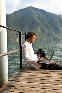 portrait of young man on the dock of lake