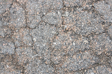 Old worn and cracked asphalt with cracks