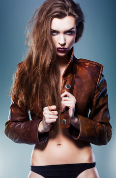 pretty erotic devil woman in leather jacket