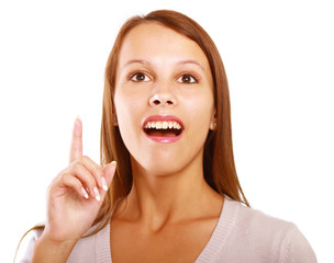 Portrait of a smiling young woman pointing up